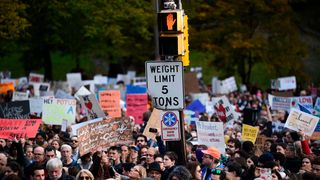 People protest the arrival of US President Donald Trump as he visits the Tree of Life Congregation on October 30, 2018 in Pittsburgh, Pennsylvania