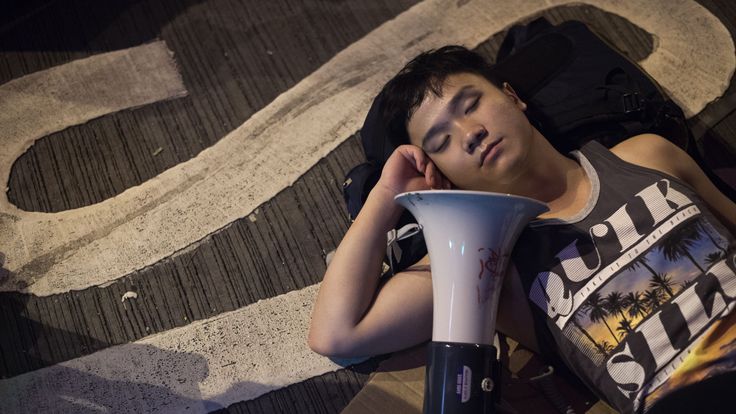 A pro-democracy protester sleeps in the street in the Mongkok district of Hong Kong on October 19, 2014