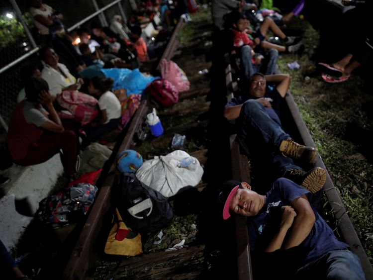 Migrants sleep on a bridge approaching the Guatemala-Mexico border