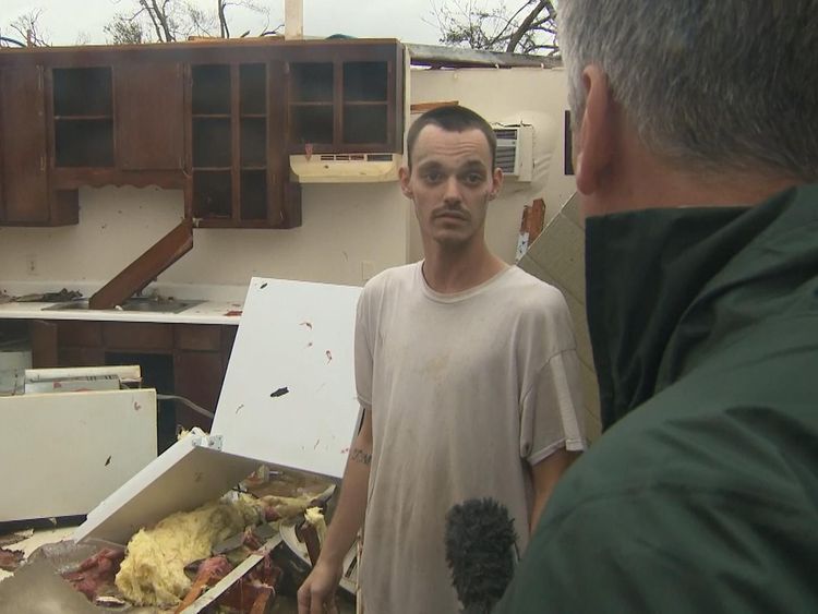 Aaron in his damaged apartment after Hurricane Michael
