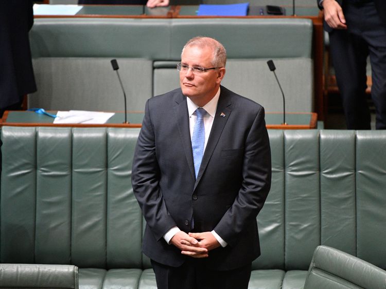 Australia's Prime Minister Scott Morrison stands before delivering the National Apology to survivors of child sexual abuse in the House of Representatives