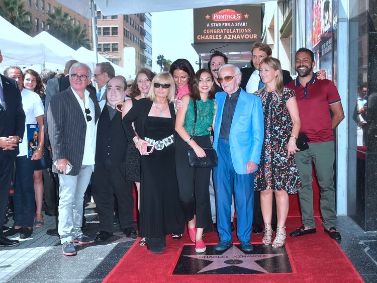 Singer Charles Aznavour poses with his family on his Hollywood Walk of Fame Star in Hollywood