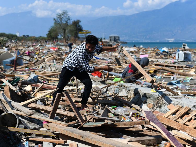 A survivor picks through debris in badly-hit Palu