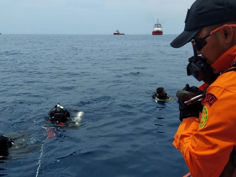 Rescue workers are seen at the site where it is believed the Lion Air flight JT610 crashed