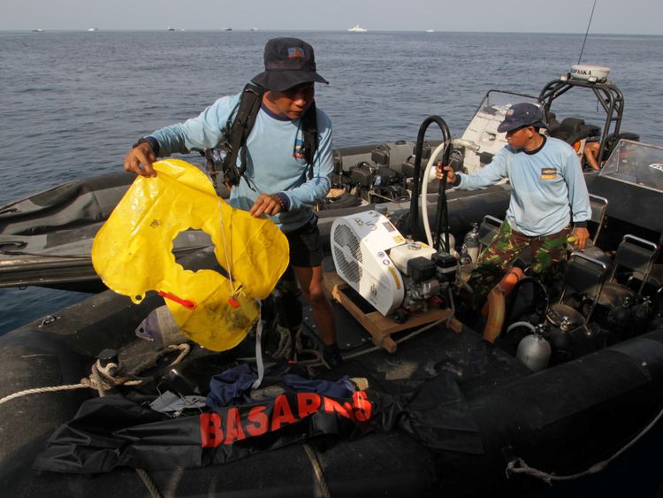 An Indonesian Navy member holds an airplane lifejacket recovered after Lion Air&#39;s, flight JT610 sea crash, off the coast of Karawang regency