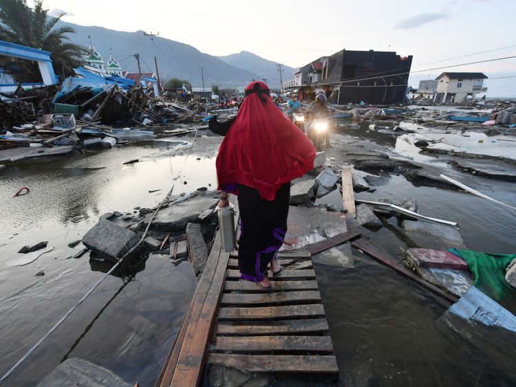 A woman walks through a devastated area in Palu, in Indonesia&#39;s Central Sulawesi 