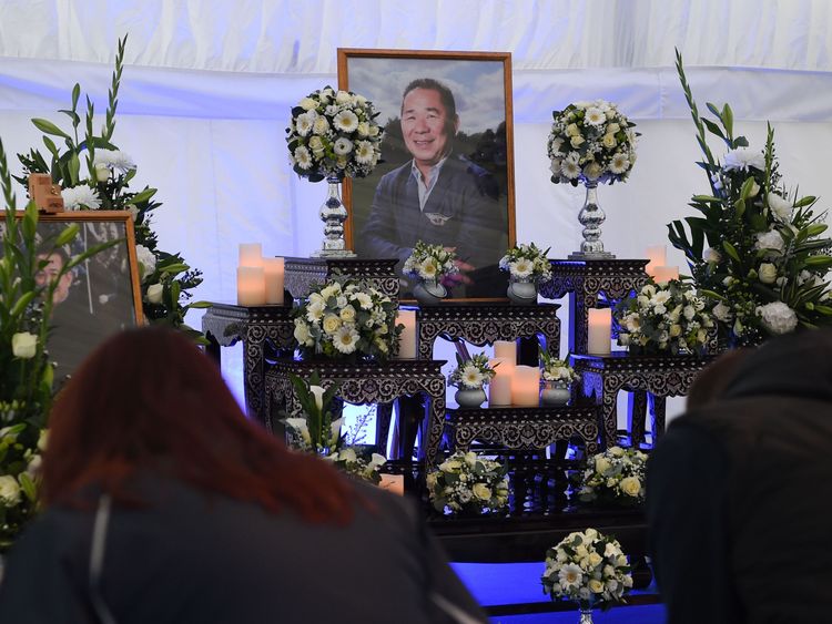 People sign a book of condolence set up outside Leicester City Football Club's King Power Stadium 