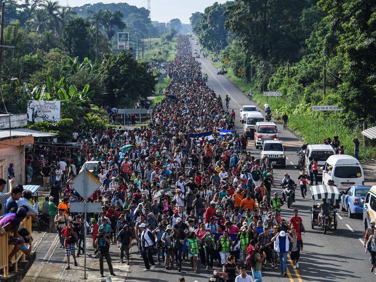 Thousands of migrants cross the Guatemala border and march north through Mexico