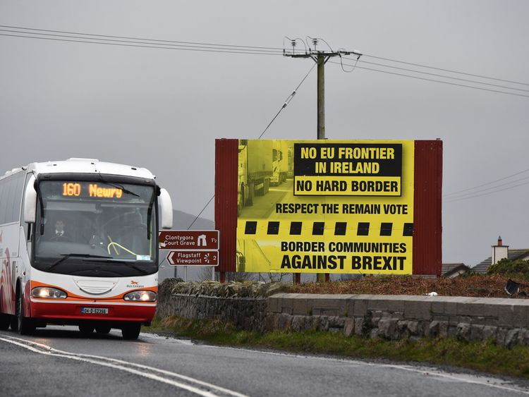 NEWRY, NORTHERN IRELAND - FEBRUARY 02: A bus crossing along the border between Northern and southern Ireland passes a sign campaigning against a so called hard Brexit, on February 2, 2017 in Newry, Northern Ireland. 