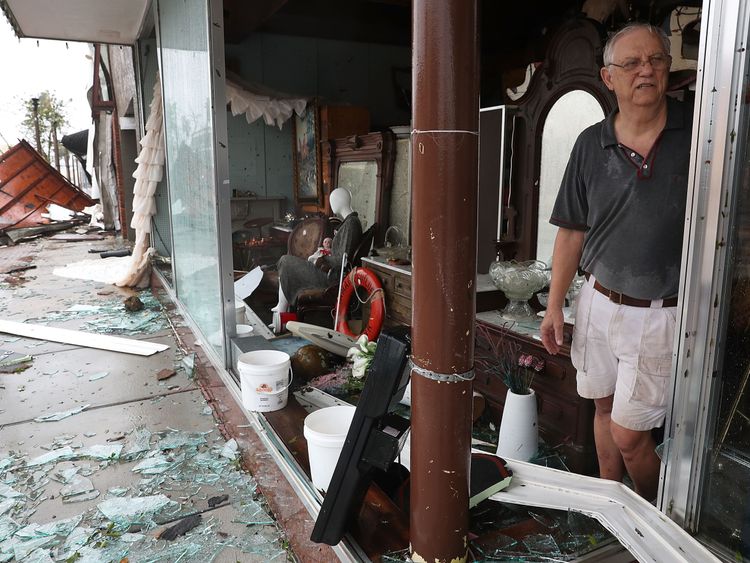 Mike Lindsey stands in his antique shop after the winds from hurricane Michael broke the windows in his shop on October 10, 2018 in Panama City