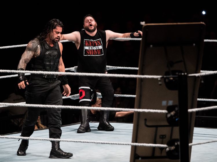 Roman Reigns (L) during a 2017 WWE Live Duesseldorf event with Kevin Owens