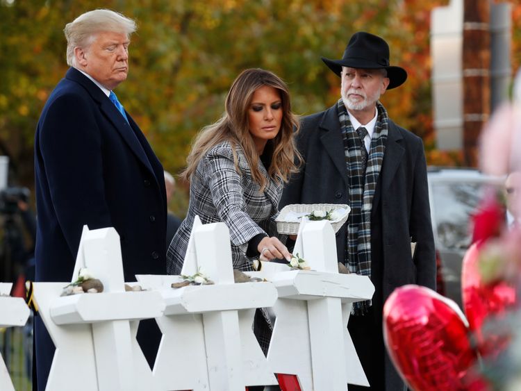 U.S. President Donald Trump and first lady Melania Trump stand with Rabbi Jeffrey Myers as they place stones at a makeshift memorial outside the Tree of Life synagogue in the wake of the shooting at the synagogue where 11 people were killed and six people were wounded in Pittsburgh, Pennsylvania, U.S., October 30, 2018