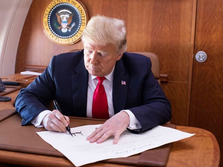 President Trump signs the commission appointing Judge Kavanaugh to the Supreme Court while on board Air Force One