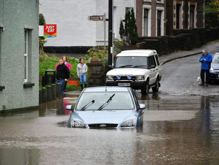 A car is stranded in floodwater in Tonna near Aberdulais in South Wales.