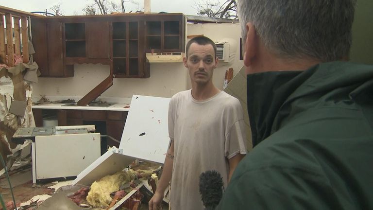 Aaron in his damaged apartment after Hurricane Michael