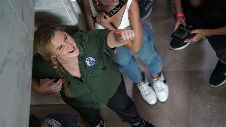 Amy Schumer waits to be led away during a protest against Supreme Court nominee Brett Kavanaugh.  