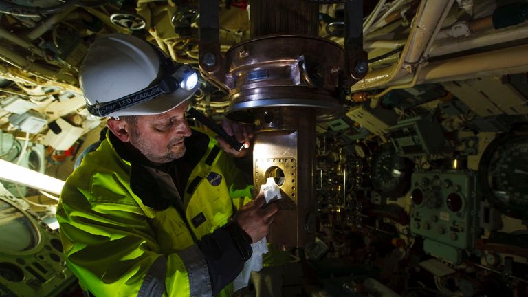 Harry MacCallum from Babcock International Group inspects the bronze attack periscope after being carefully returned to HMS Alliance at the Royal Navy Submarine Museum in Gosport, Hampshire