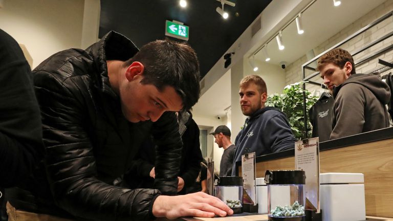 A customer looks at cannabis on display after legal recreational marijuana went on sale at a Tweed retail store in St John&#39;s, Newfoundland and Labrador, Canada