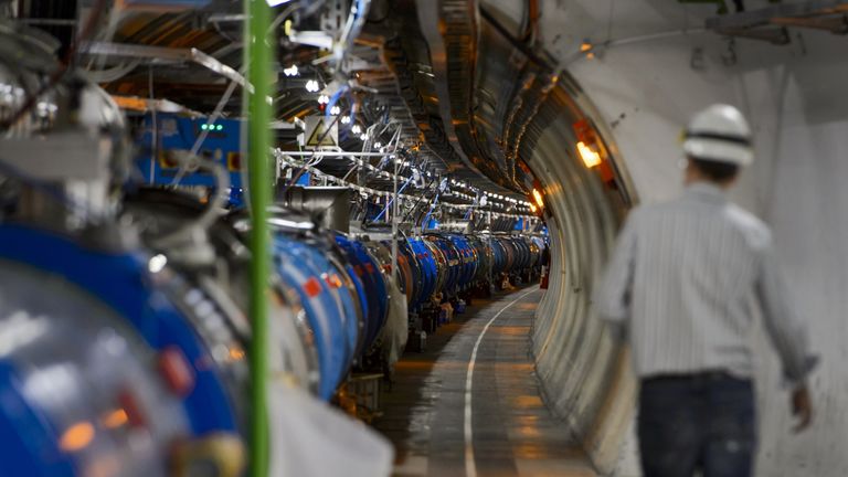  A scientist walks in a tunnel inside the European Organisation for Nuclear Research (CERN) Large Hadron Collider (LHC), during maintenance works on July 19, 2013 in Meyrin