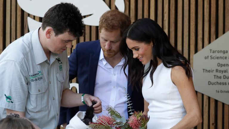 Prince Harry and Meghan, Duchess of Sussex are shown a Yellow Bellied Glider during a ceremony at Taronga Zoo in Sydney