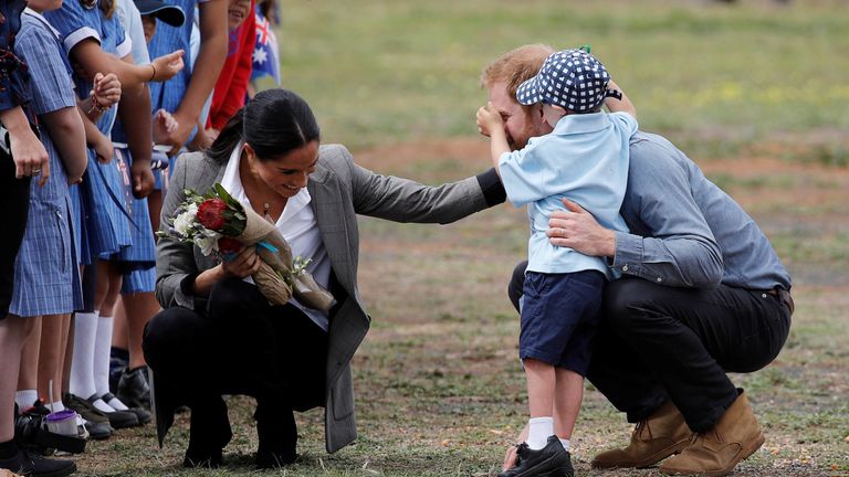 Prince Harry and Meghan, Duchess of Sussex, interact with Luke Vincent, 5, after arriving at Dubbo airport