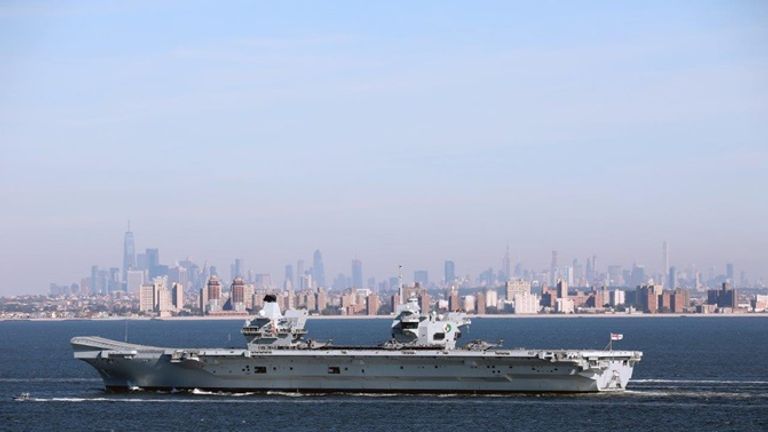 HMS Queen Elizabeth sails by the iconic Manhattan skyline