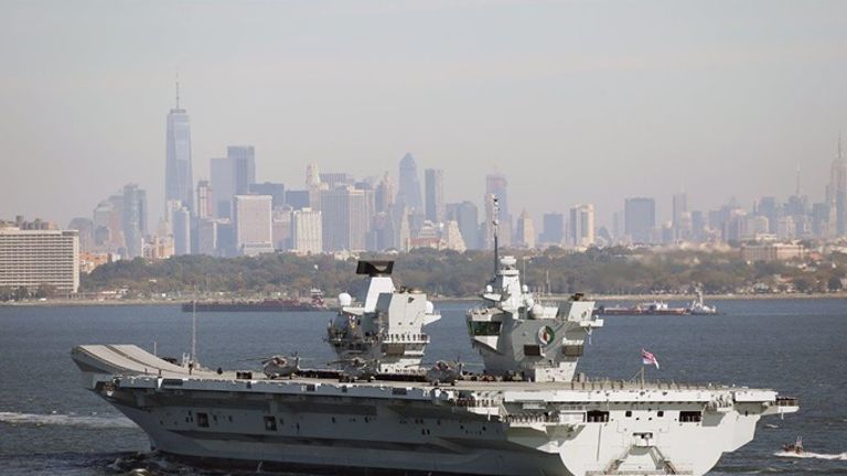 HMS Queen Elizabeth sails by the iconic New York skyline