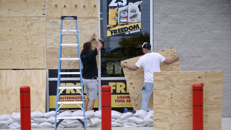 Justin Davis, left, and Brock Mclean board up a business in advance of Hurricane Michael in Destin, Florida