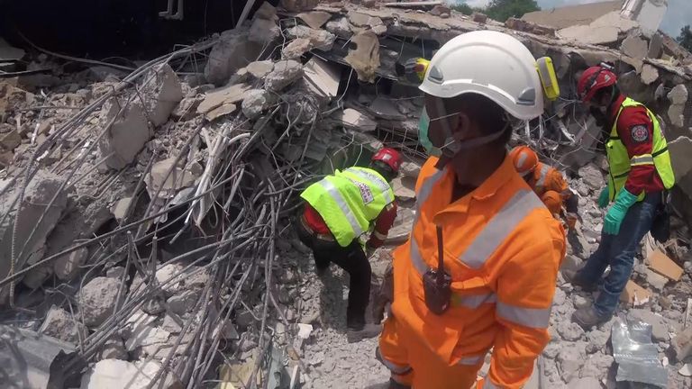 Rescuers search the rubble for victims
