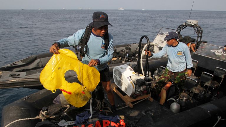 An Indonesian Navy member holds an airplane lifejacket recovered after Lion Air&#39;s, flight JT610 sea crash, off the coast of Karawang regency