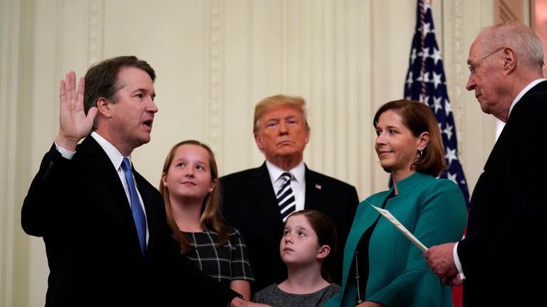 U.S. Supreme Court Associate Justice Brett Kavanaugh participates in his ceremonial public swearing-in with retired Justice Anthony Kennedy as U.S. President Donald Trump and Kavanaugh&#39;s wife Ashley and daughters Liza and Margaret look on in the East Room of the White House in Washington, U.S., October 8, 2018
