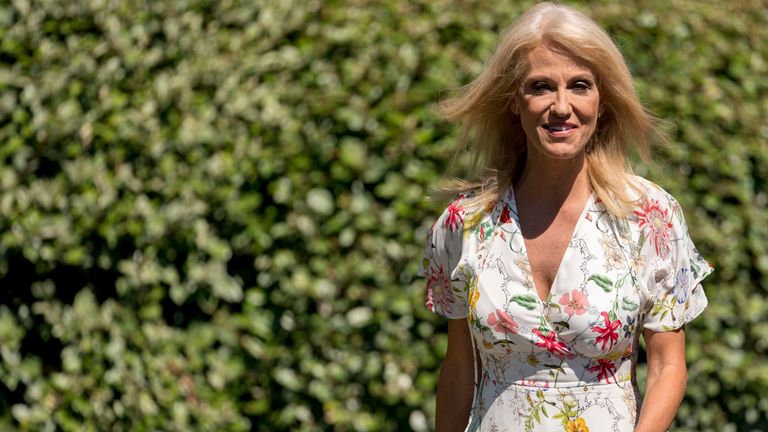 Kellyanne Conway walks towards the West Wing of the White House