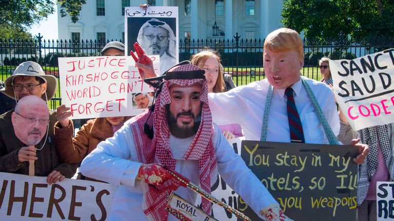 Demonstrators dressed as Saudi Arabian Crown Prince Mohammed bin Salman and US President Donald Trump (C) protest outside the White House in Washington, DC, on October 19, 2018, demanding justice for missing Saudi journalist Jamal Khashoggi