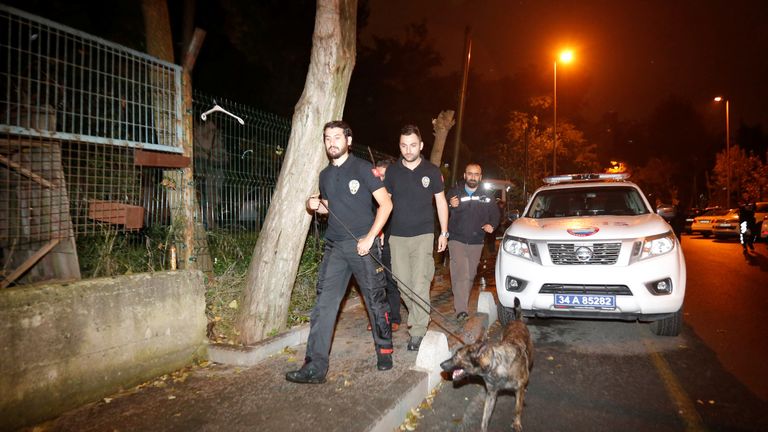 Turkish police officers and a sniffer dog examine the outside of the Saudi consul&#39;s home in Istanbul