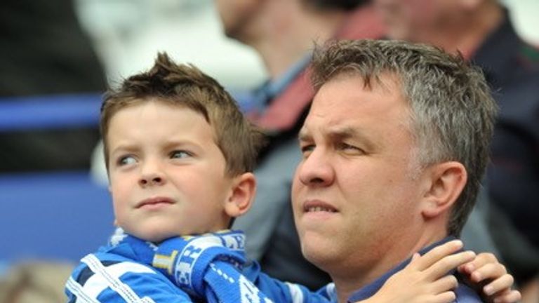 Leicester City fan and journalism lecturer Lee Marlow with his son Lucas at a game