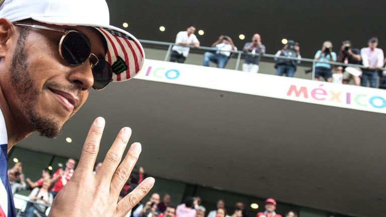 Lewis Hamilton gestures the number of world titles he&#39;s now won
