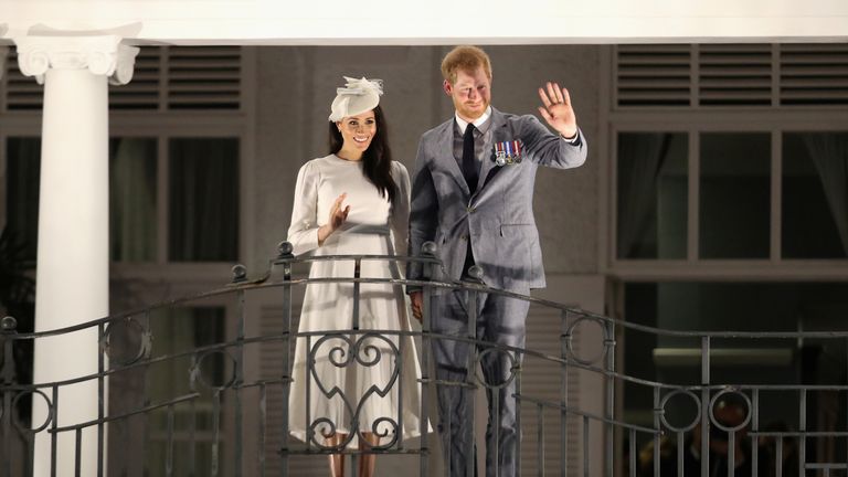 Britain&#39;s Prince Harry and Meghan, Duchess of Sussex wave from the balcony of the Grand Pacific Hotel in Suva, Fiji October 23, 2018. Chris Jackson/Pool via REUTERS