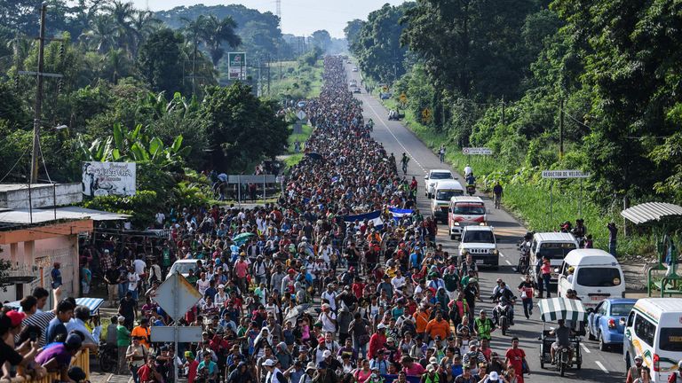 Thousands of migrants cross the Guatemala border and march north through Mexico