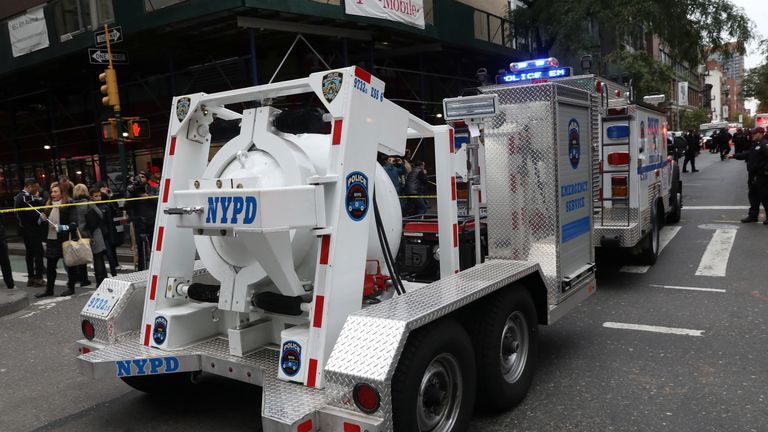 Police remove the suspicious package sent to James Clapper in New York