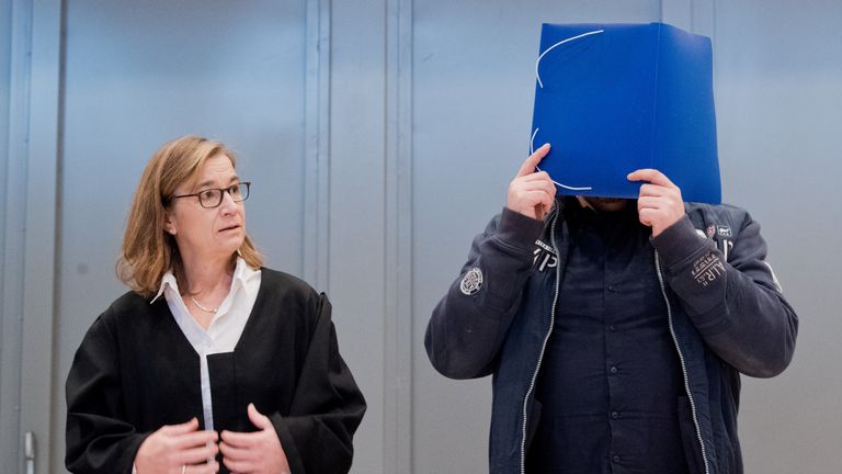 Former nurse Niels Hoegel covers his face as he arrives for the start of his trial in a courtroom in Oldenburg, Germany, October 30, 2018. Julian Stratenschulte/Pool via REUTERS
