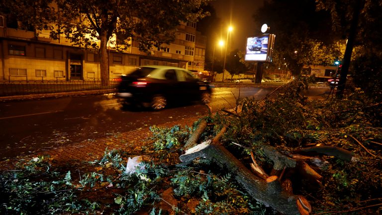 Tree branches litter a street in Benfica neigborhood as storm Leslie hits