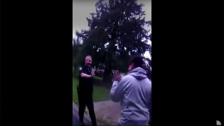 Chris gets a high five from an officer after the squirrel jumps back up