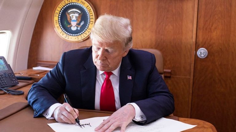 President Trump signs the commission appointing Judge Kavanaugh to the Supreme Court while on board Air Force One