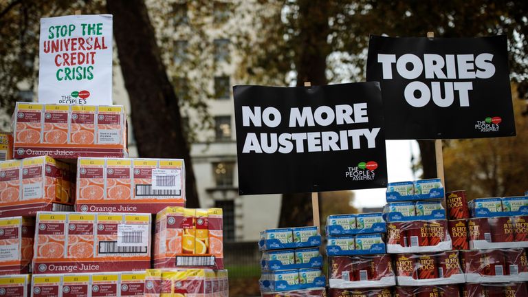 A protester stages a food bank demonstration on Whitehall complete with tons of packaged food against the Government&#39;s Universal Credit programme on November 21, 2017