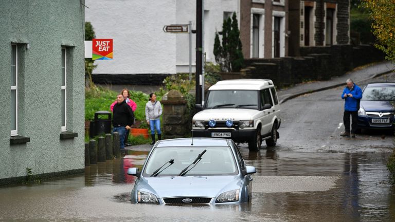 A car is stranded in floodwater in Tonna near Aberdulais in South Wales.