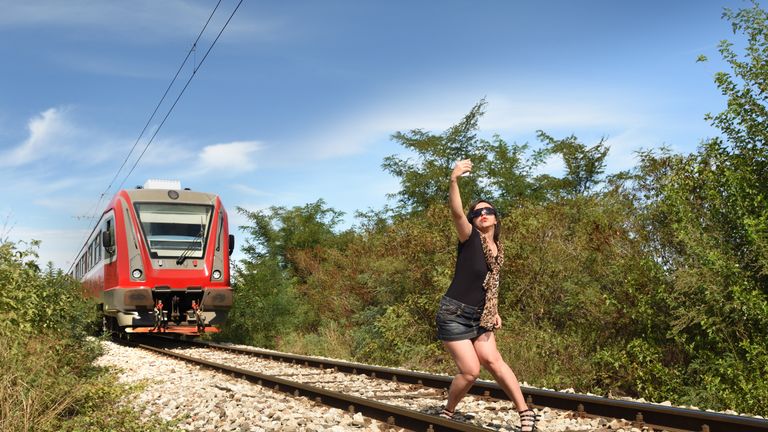 Woman taking dangerous selfie on railway track. File pic