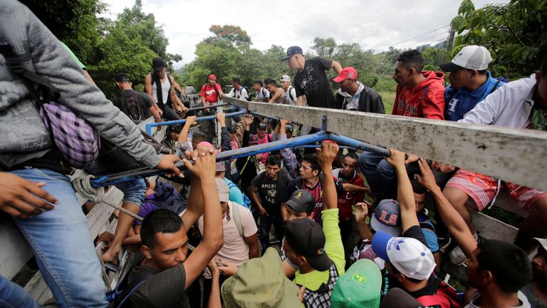 Honduran migrants board trucks sending them back to Honduras after they crossed the border into Guatemala illegally in their bid to reach the US
