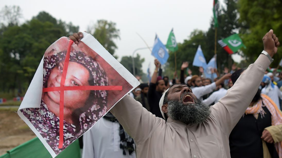 A supporter of the Ahle Sunnat Wal Jamaat (ASWJ), a hardline religious party, holds an image of Asia Bibi during a protest rally 