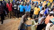 Newly arrived refugees from South Sudan receive a portion of sorghum