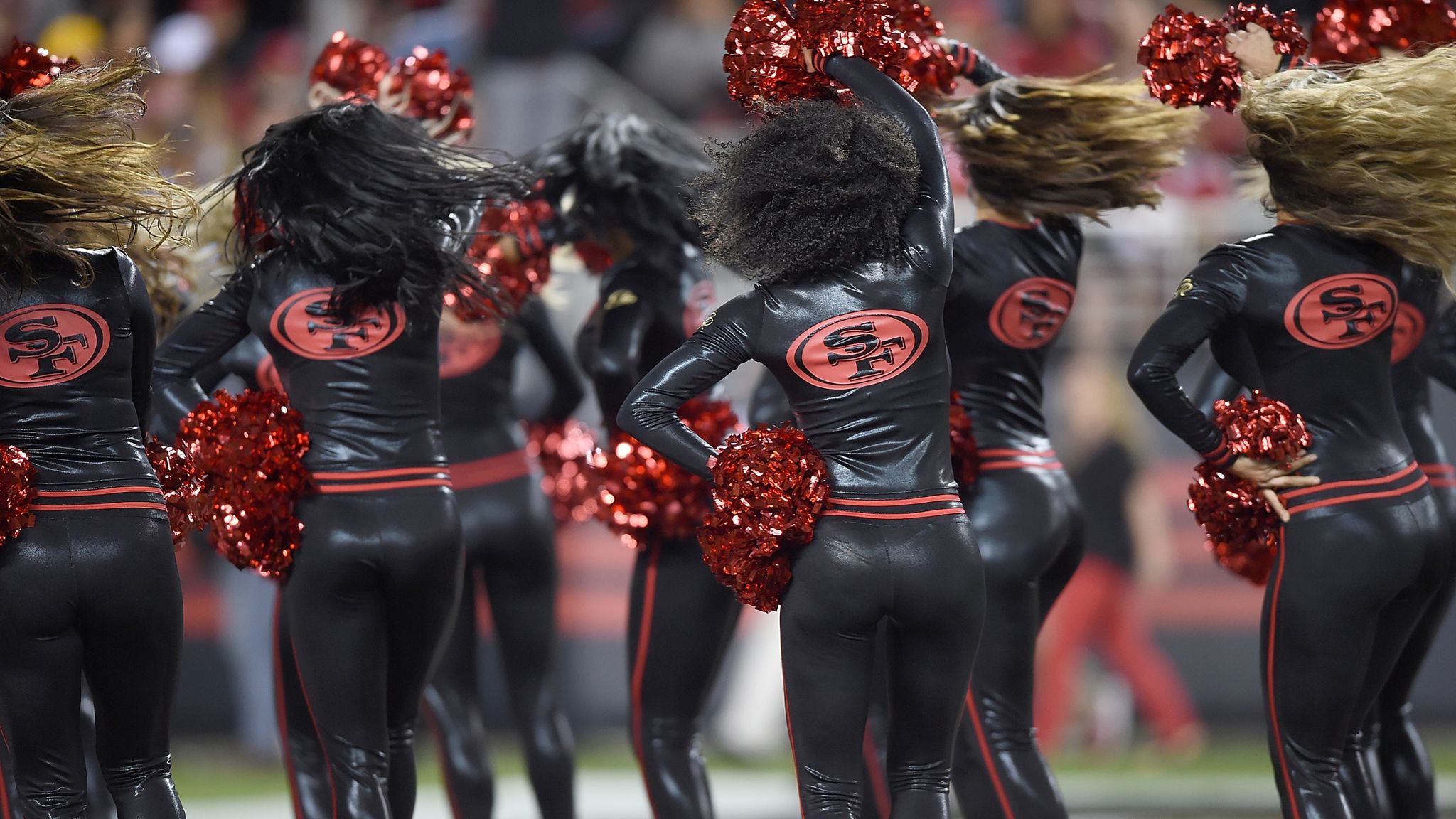 San Francisco 49ers cheerleader kneels during national anthem